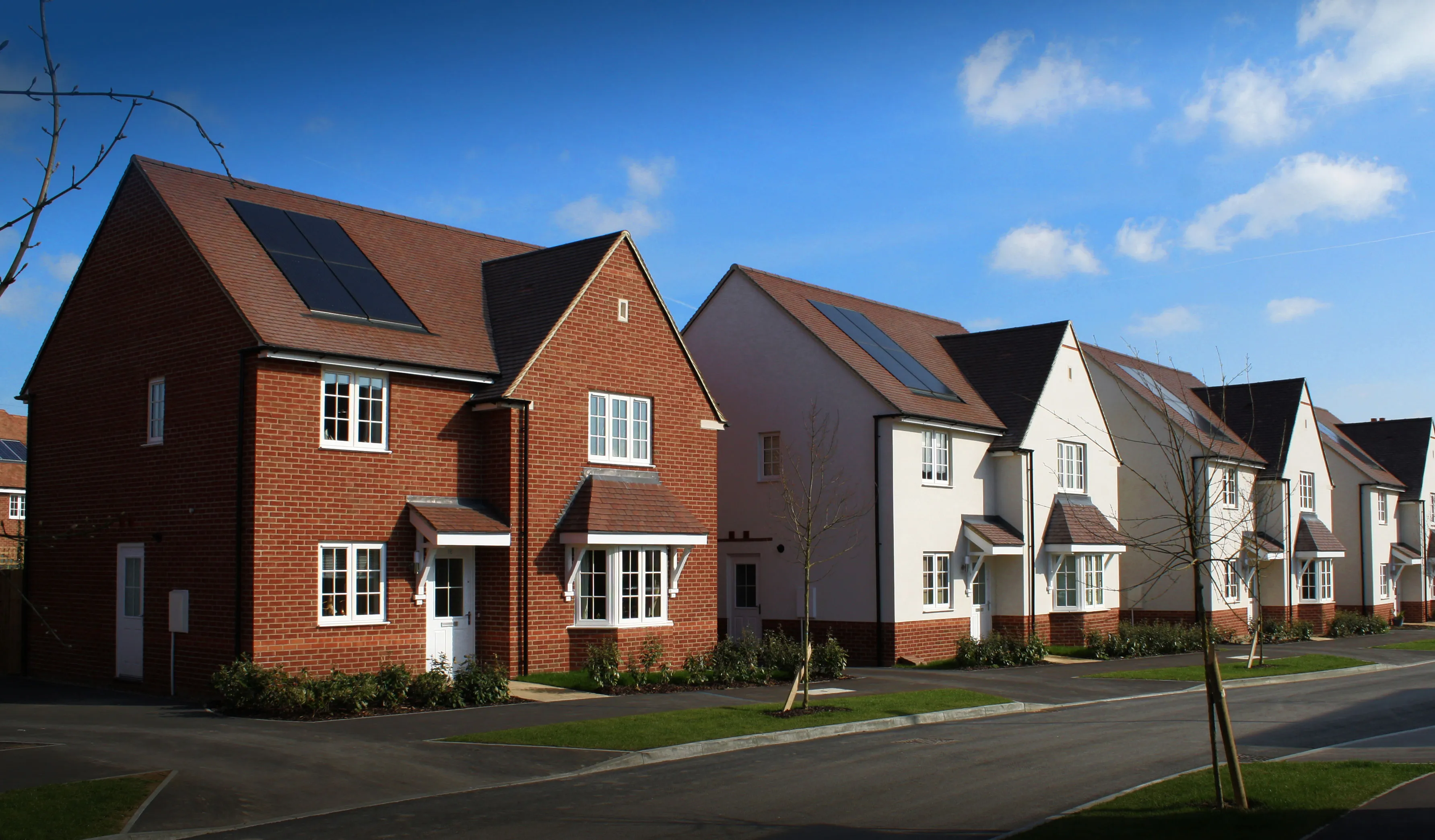 Row of modern suburban houses with solar panels on roofs