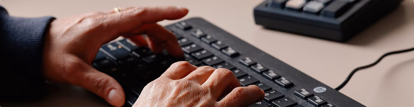 Hands typing on a keyboard