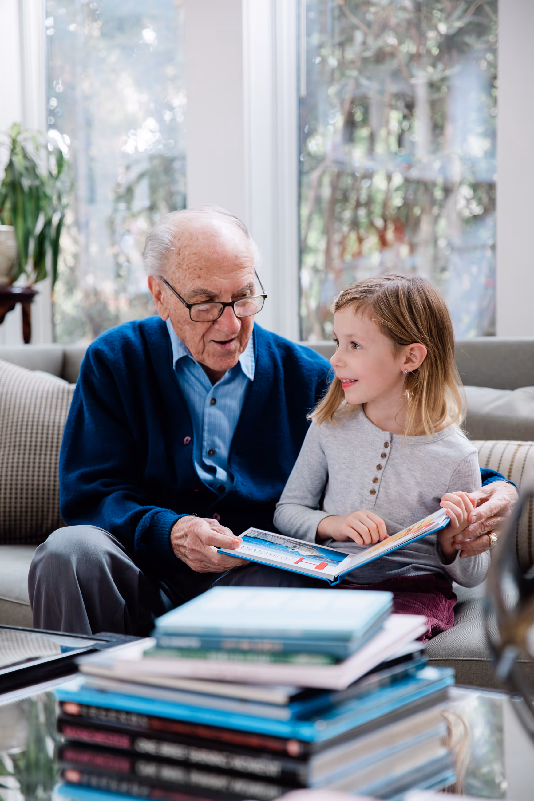 Grandfather reading custom book to happy granddaughter