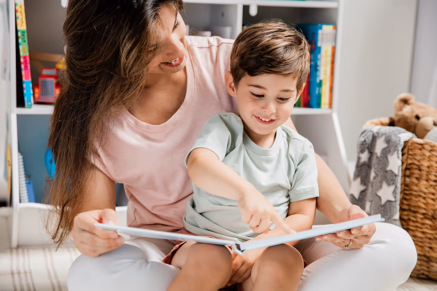 Mother and toddler son reading Stareworthy book together