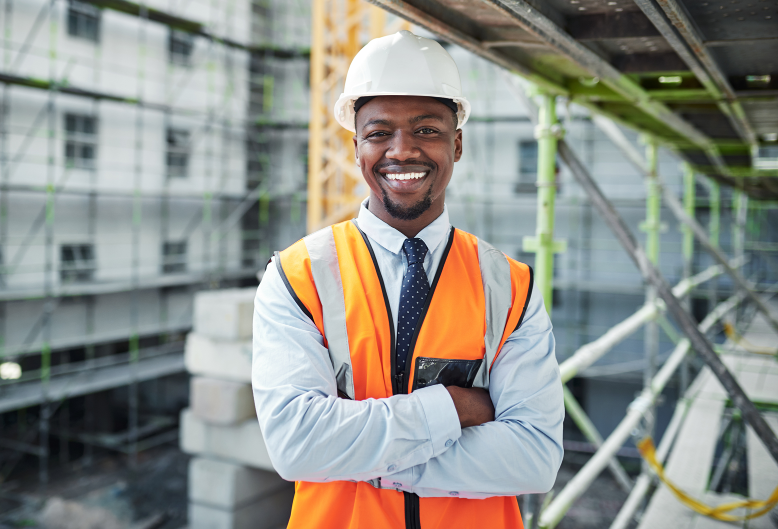 A image a guy smiling in safety vest