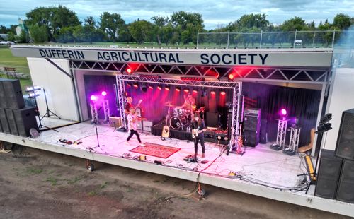There are three people performing on the stage.