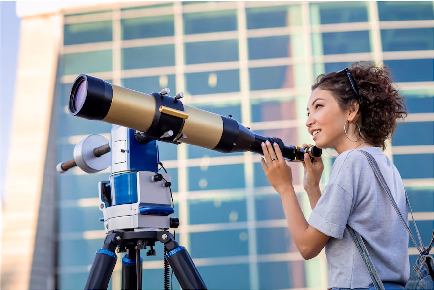 Woman looking through telescope representing strategic horizon scanning