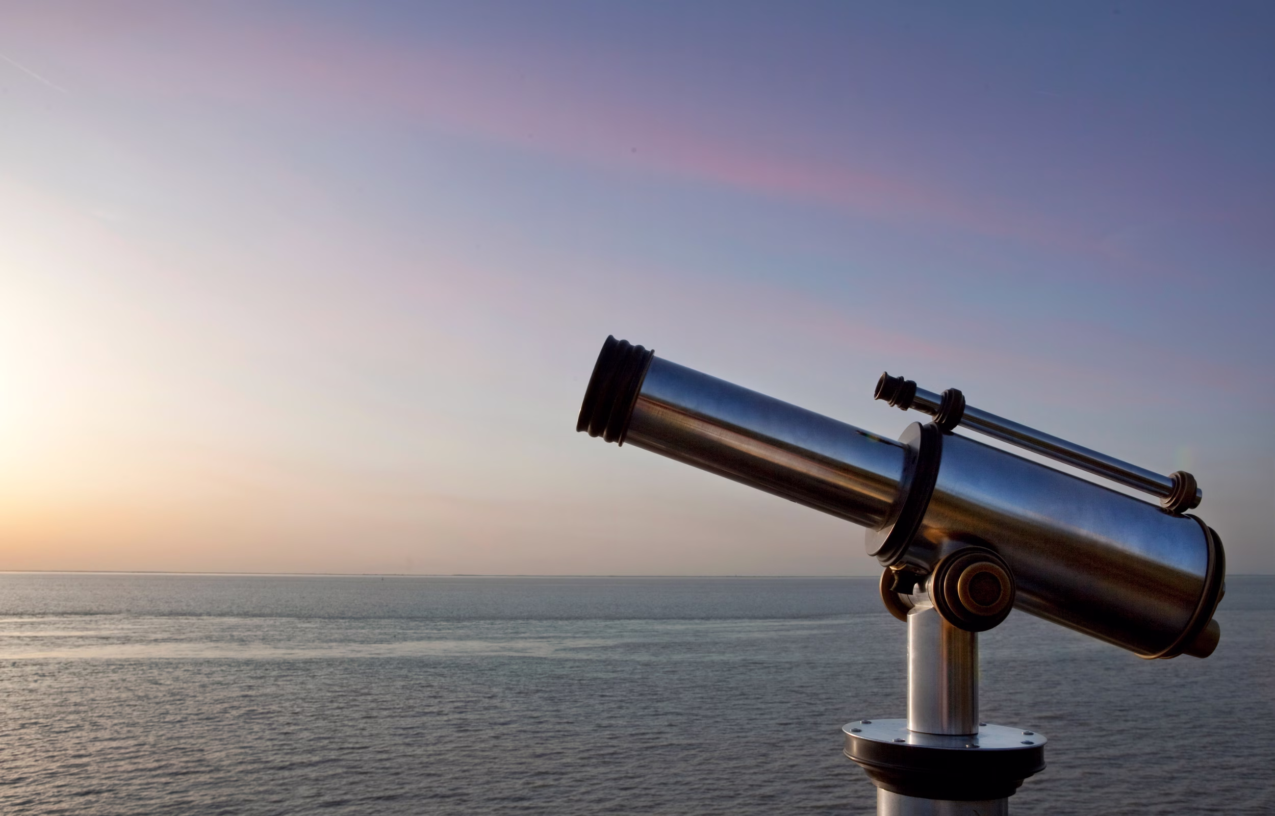 A telescope pointed toward the horizon at dusk — representing the practice of horizon scanning as detecting signals before they reach mainstream awareness
