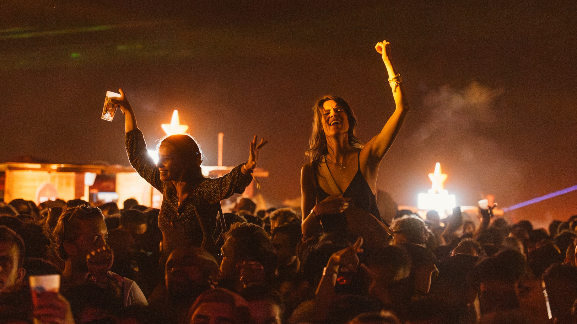 MOGA Caparica crowd dancing under warm lights at night