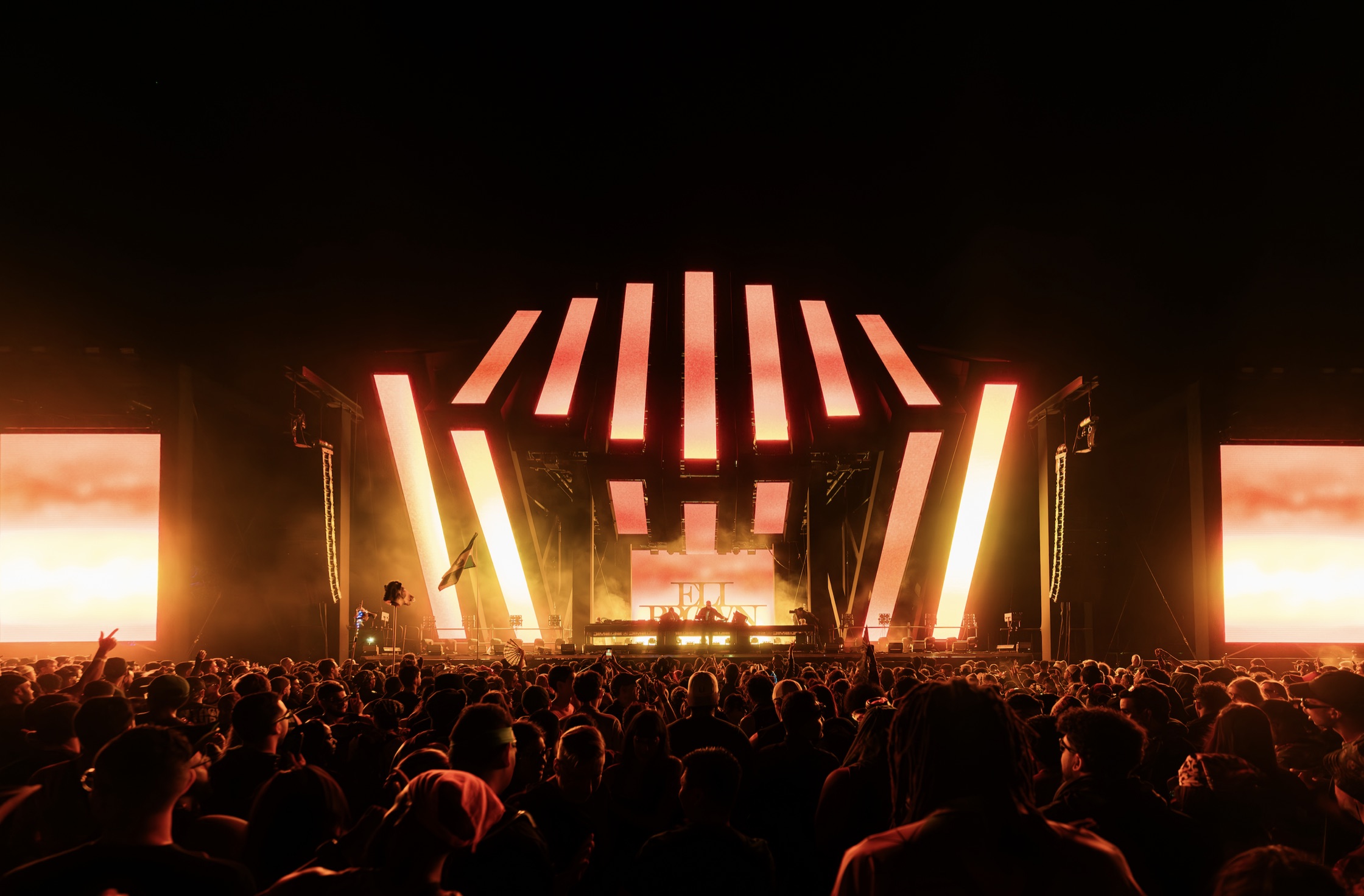 Crowd facing an illuminated stage at Seismic Dance Event