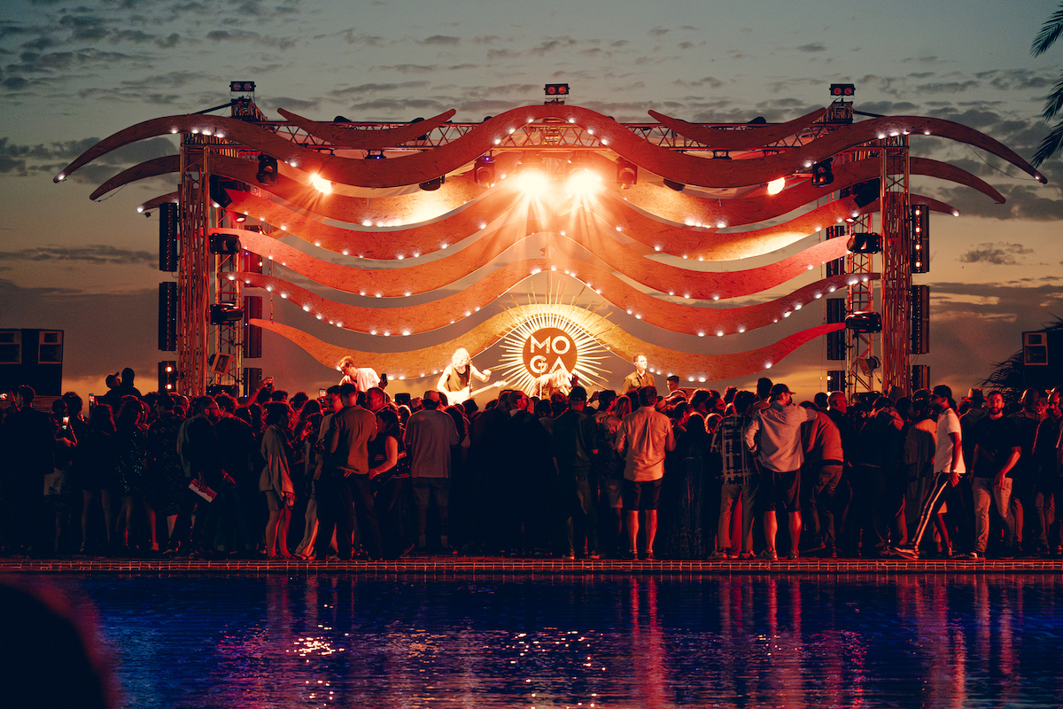MOGA stage and crowd beside the pool at sunset in Essaouira