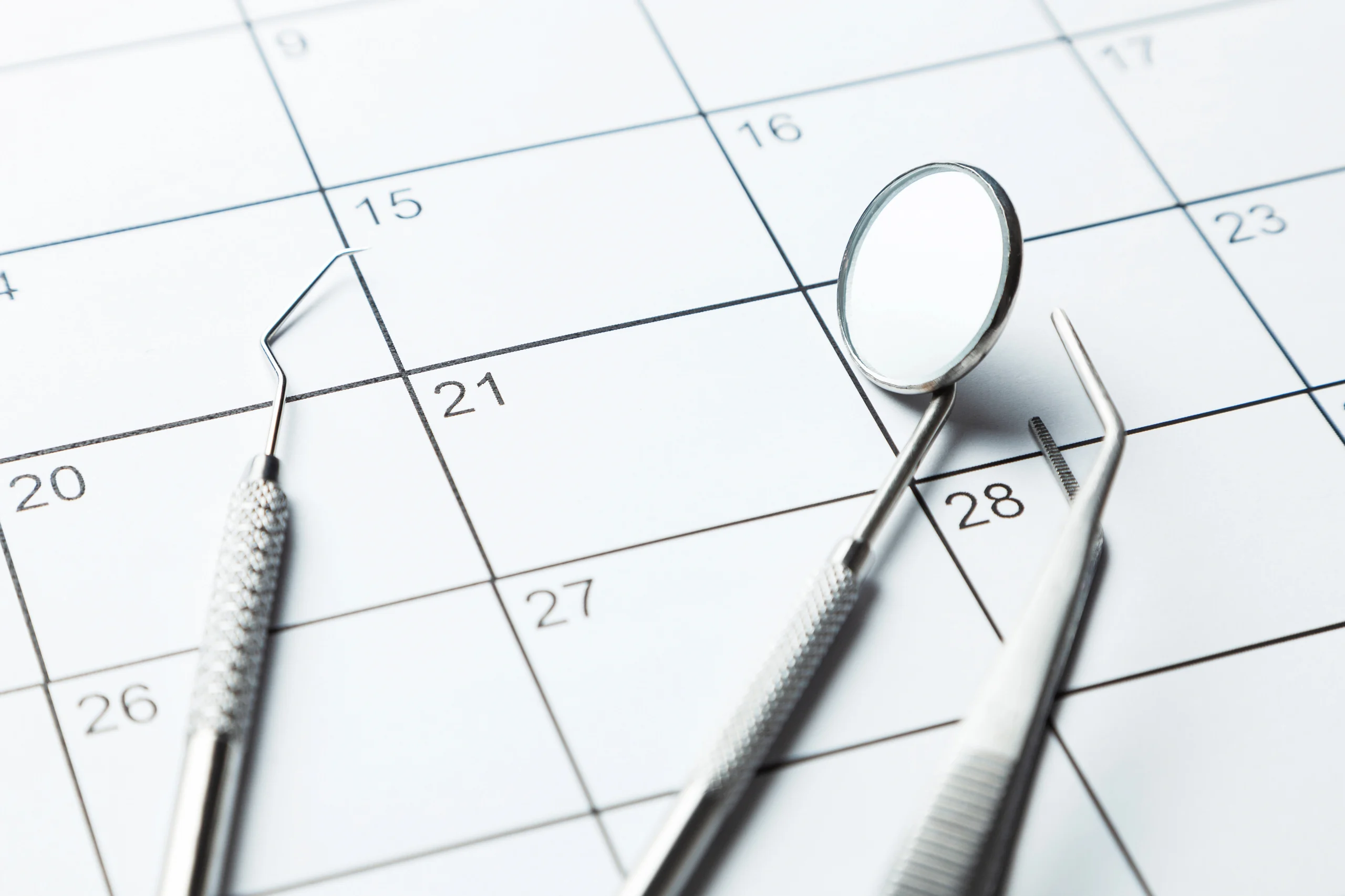 Dental tools on a calendar, scheduling a dentist appointment