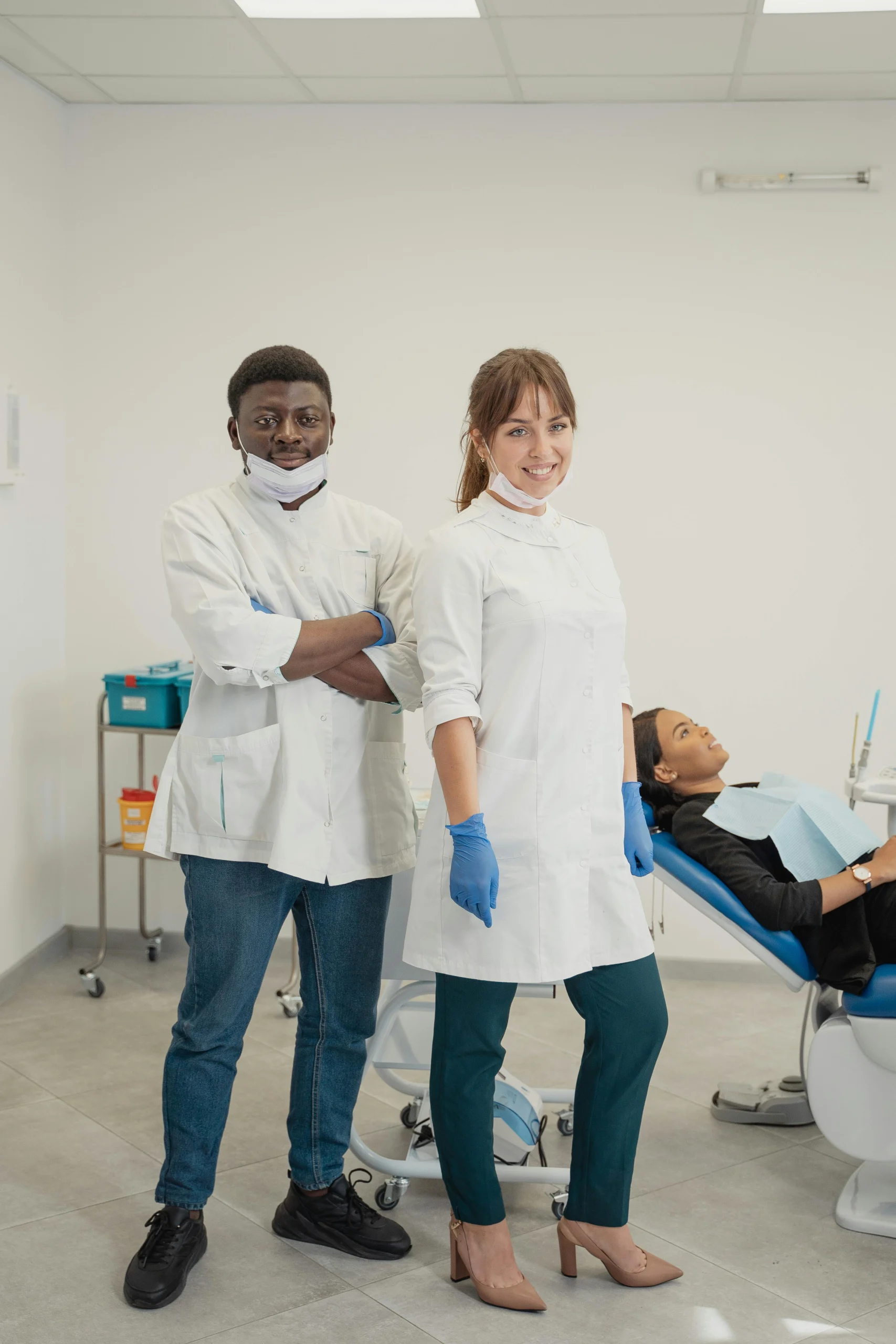 Two dental professionals standing confidently in a medical clinic