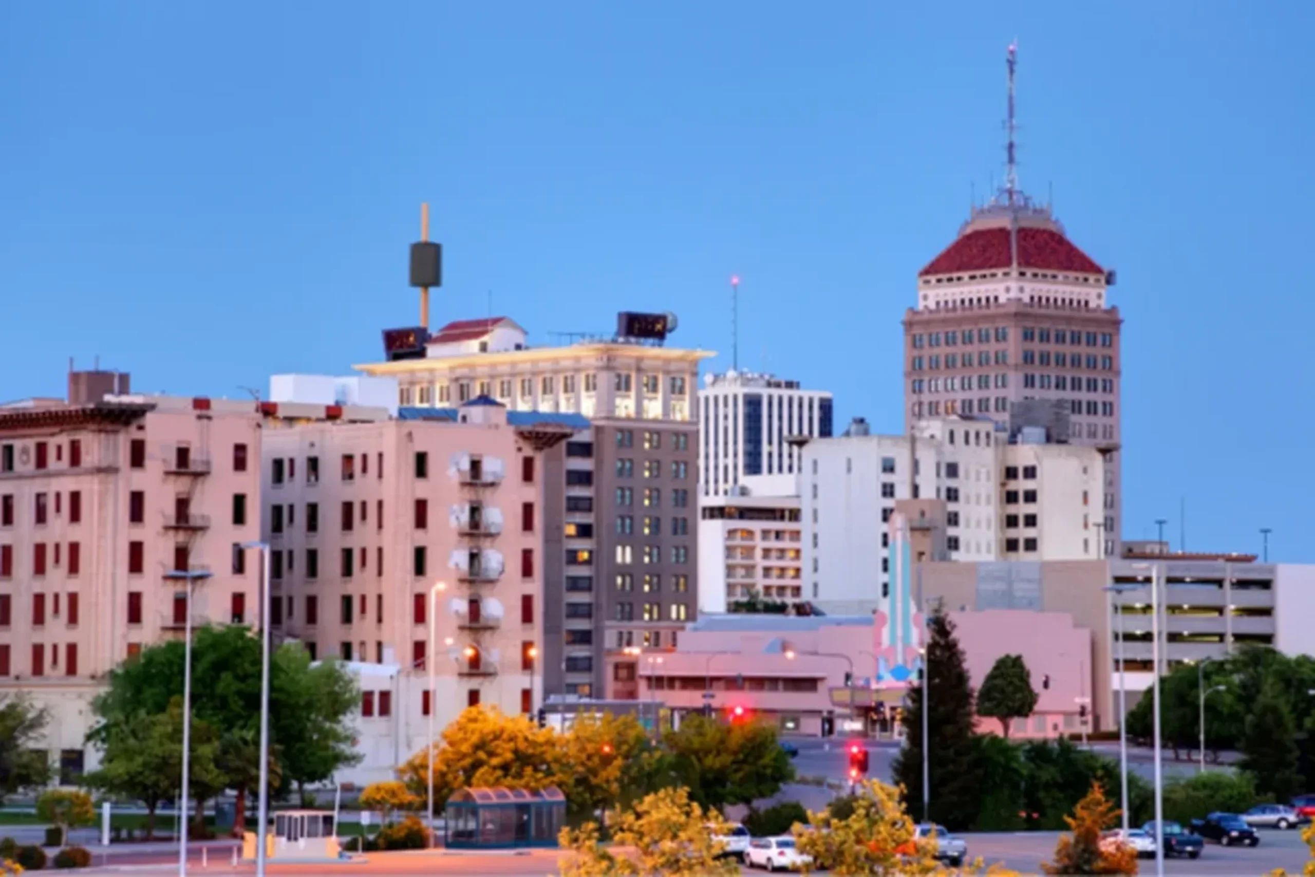 Fresno skyline with downtown buildings and yellow flowering trees