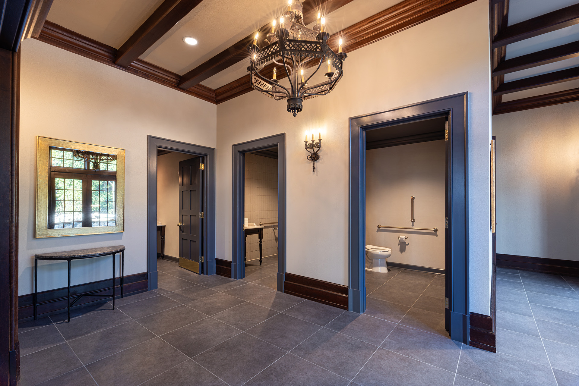 Restroom interior renovation at Longview Country Club with traditional wood trim and architectural detailing by Ossa Studio.