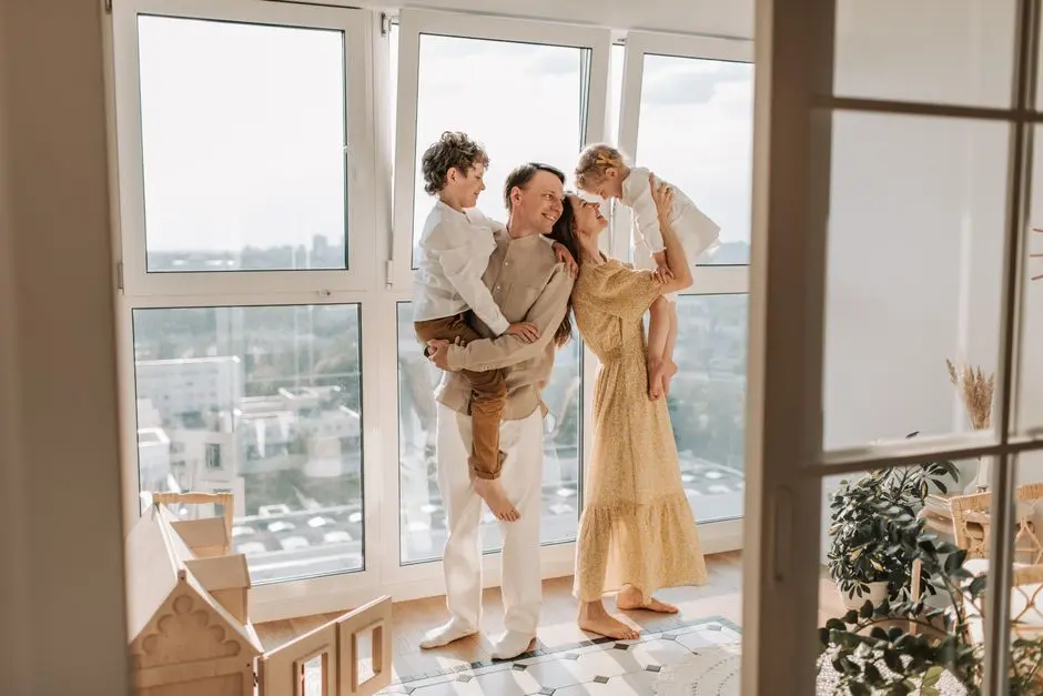 Happy family with children enjoying time together in a sunlit modern apartment.