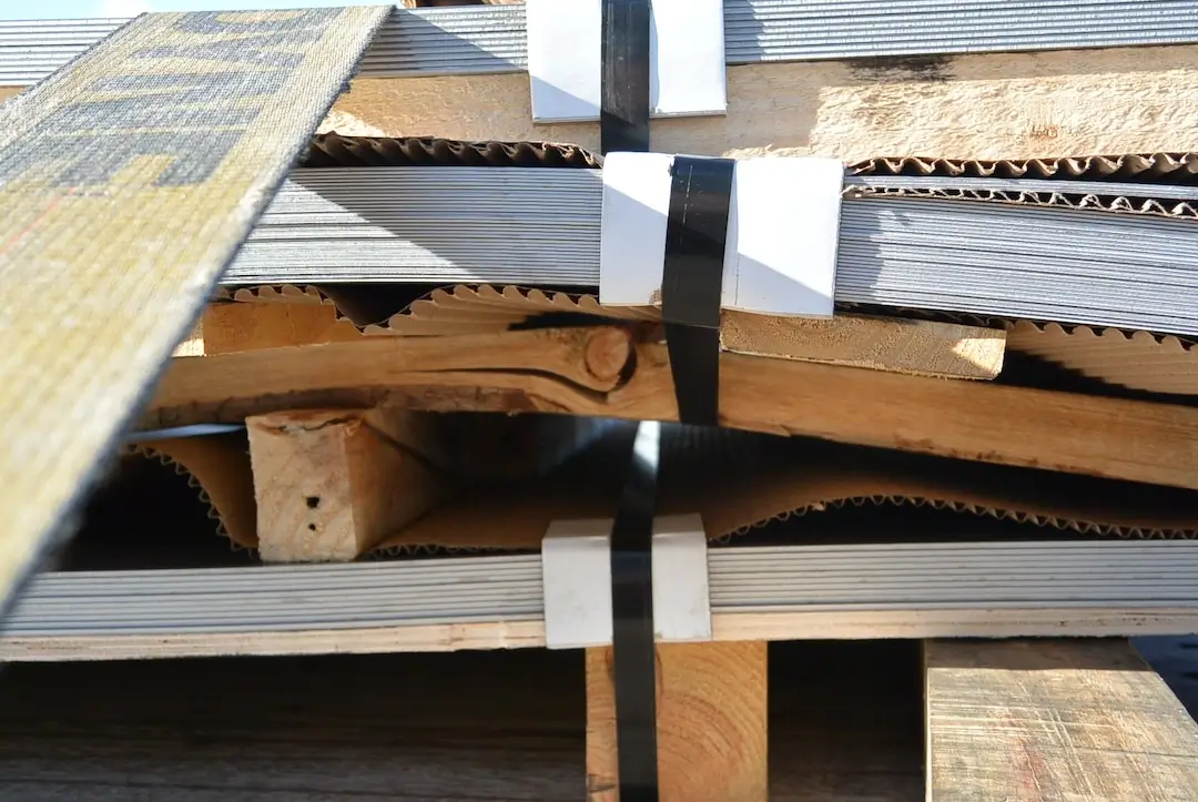 Close up of the risks of transporting raw sheet metal with wooden pallet stacking