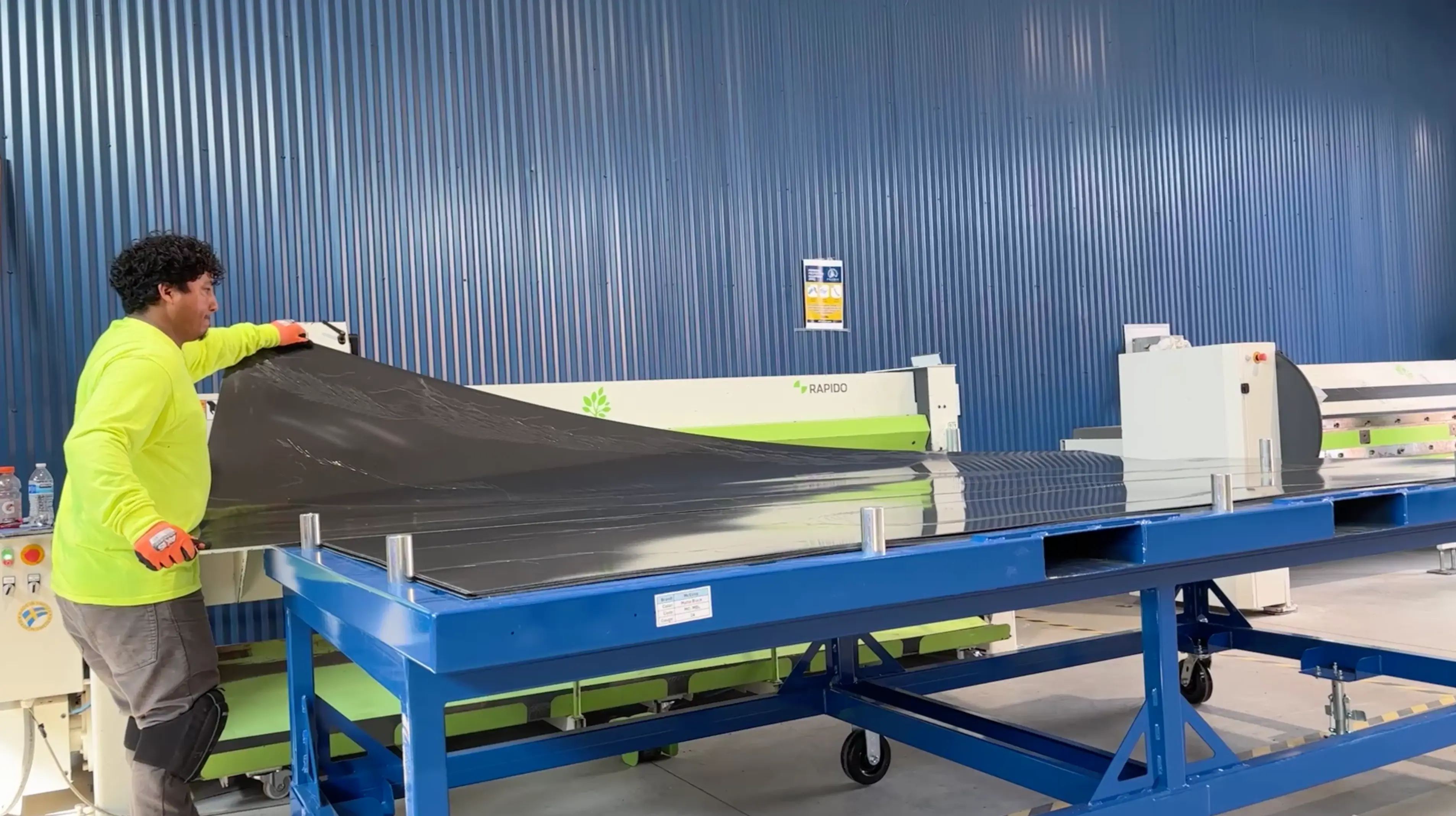 machine operator inserting sheet metal directly from returnable cartidge