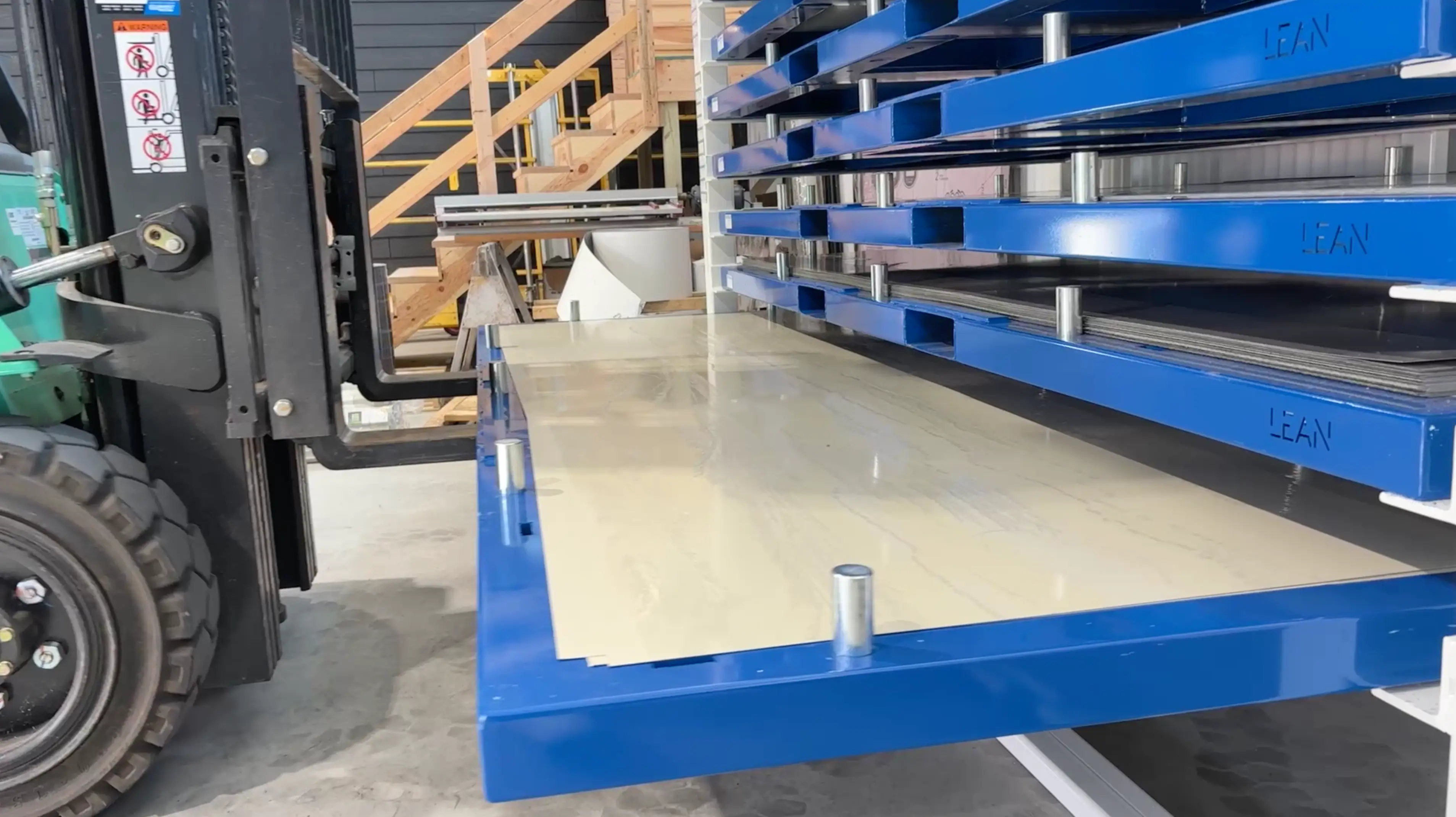 forklift operator removing cartridges from sheet metal storage rack