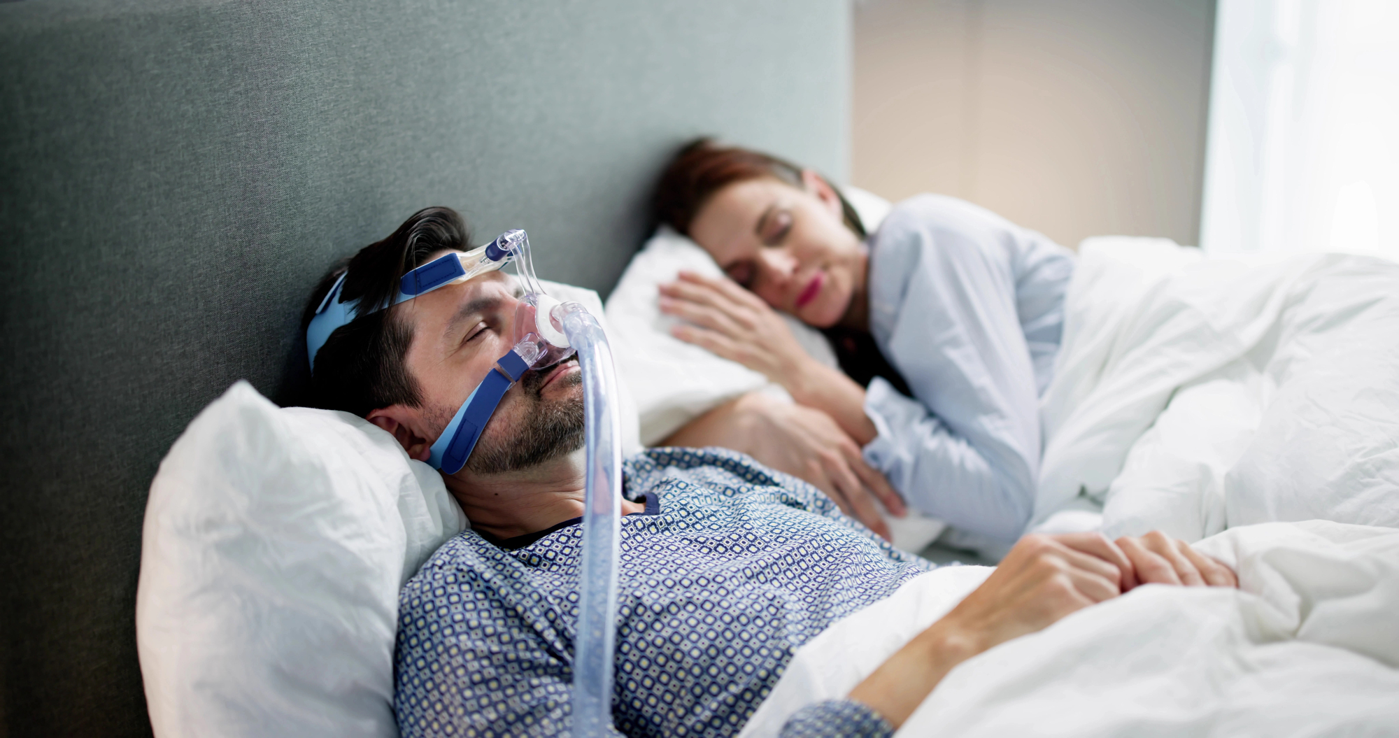 man with cpap machine as sleep apnea treatment fairfax
