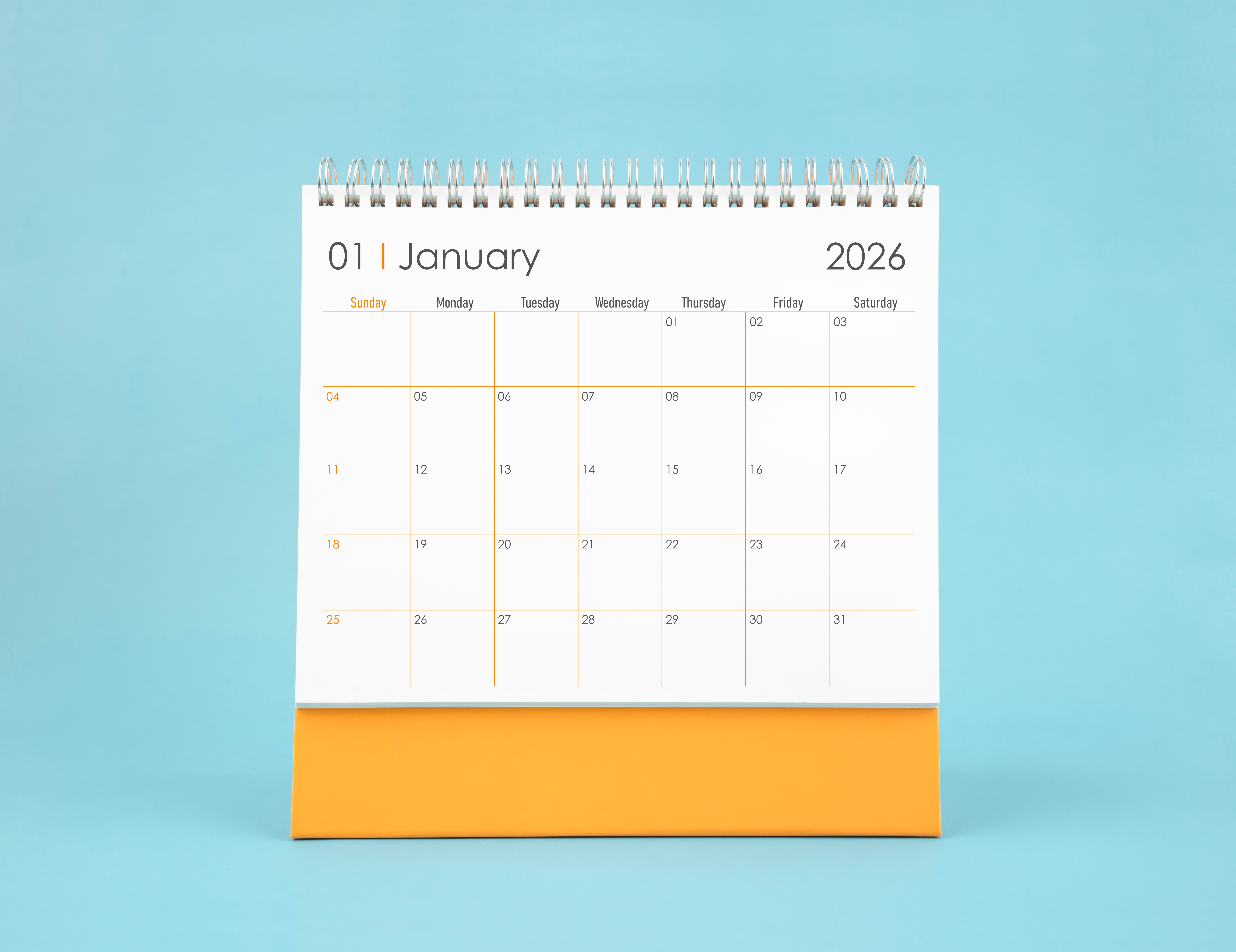 Minimalist desk calendar displaying January 2026 on a light blue background with a yellow base.
