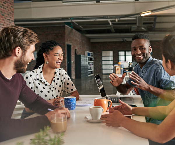 An image of a productive team enjoying time together in a workplace with high morale.