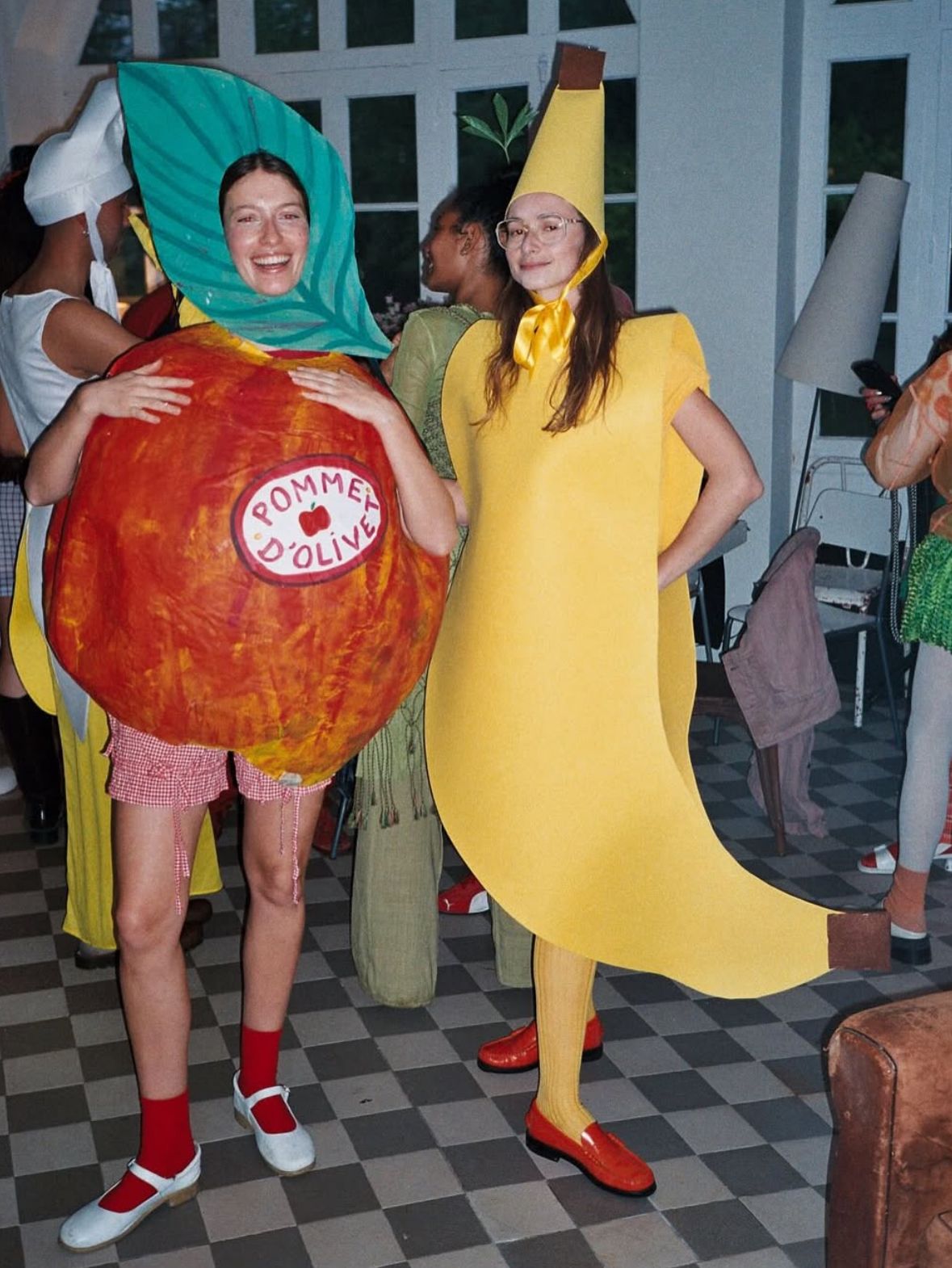 Two people in tomato and banana costumes