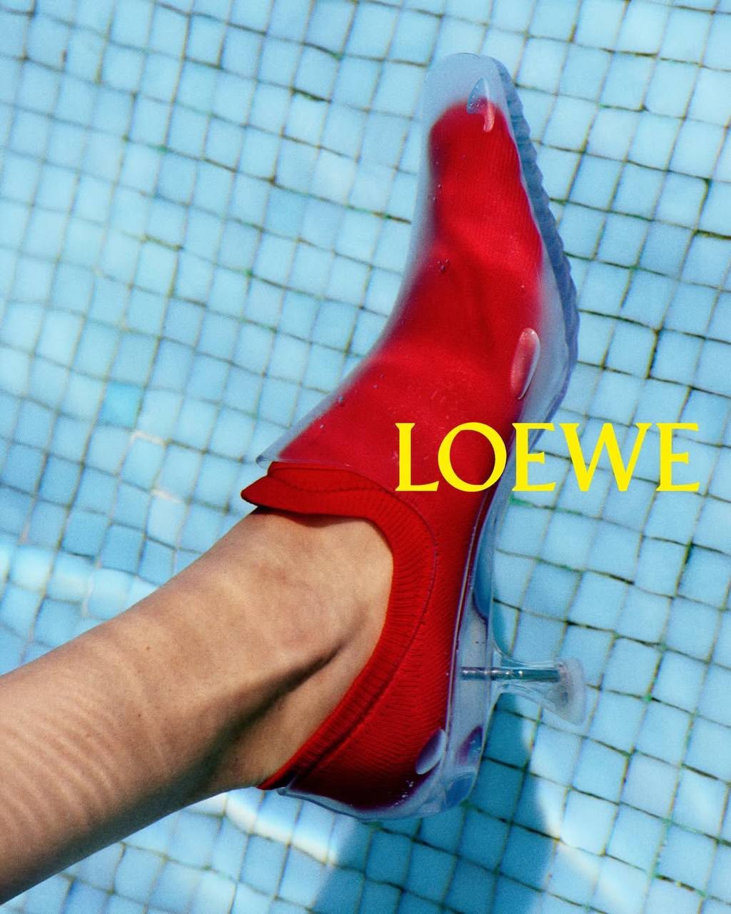 Red shoe dipped into a tiled pool