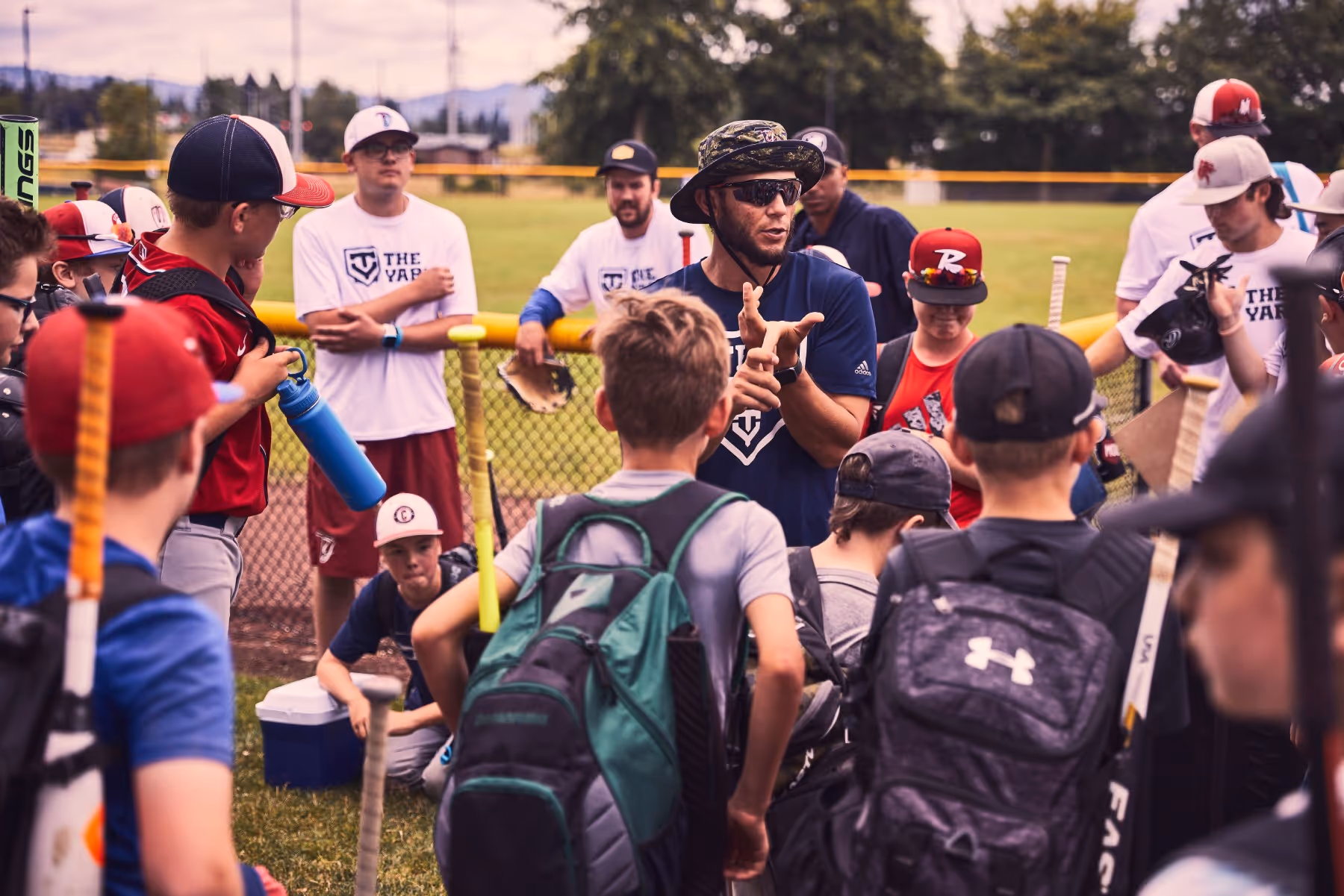 A group of young men standing next to each other on a field.