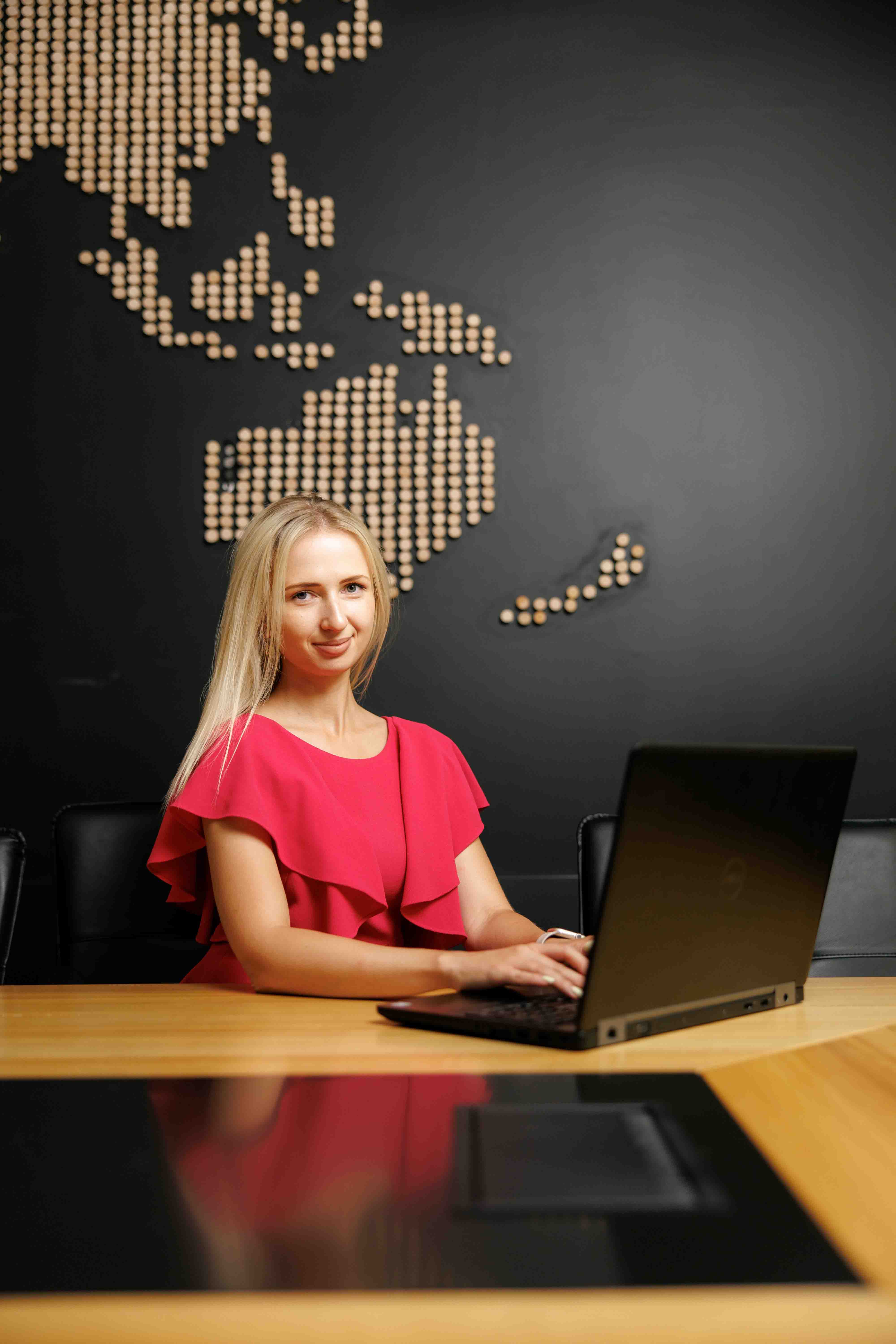 An image of a business woman next to the laptop, working for Pharmbills