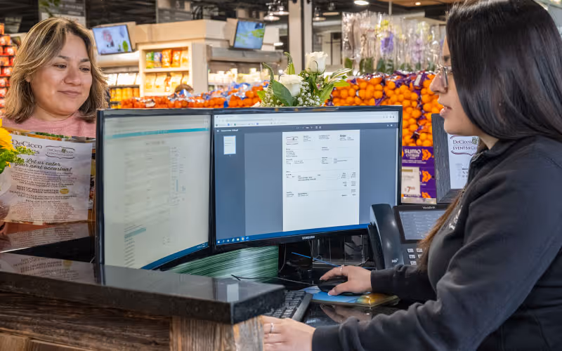shop assistant and a customer in a grocery store