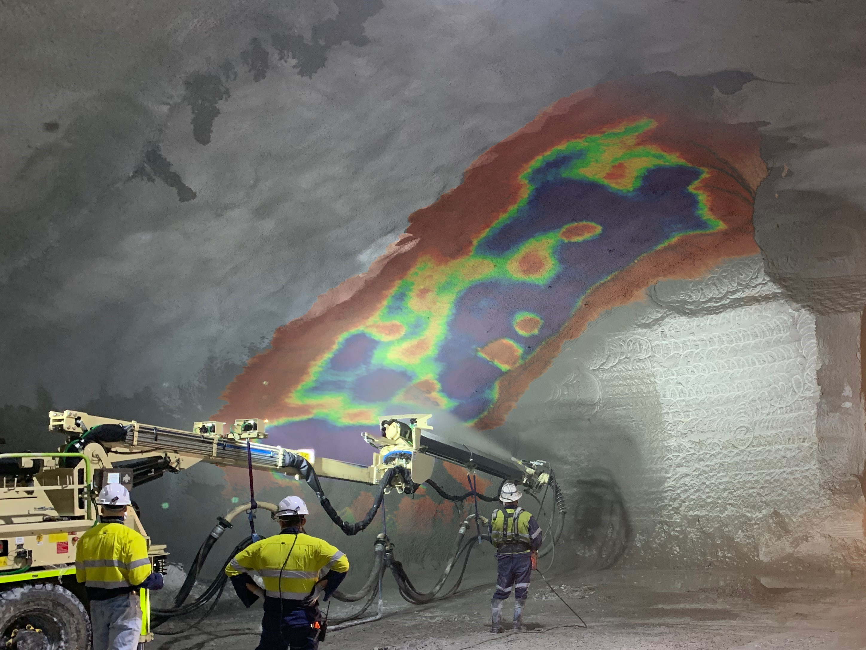 shotcrete being sprayed onto a tunnel wall underground