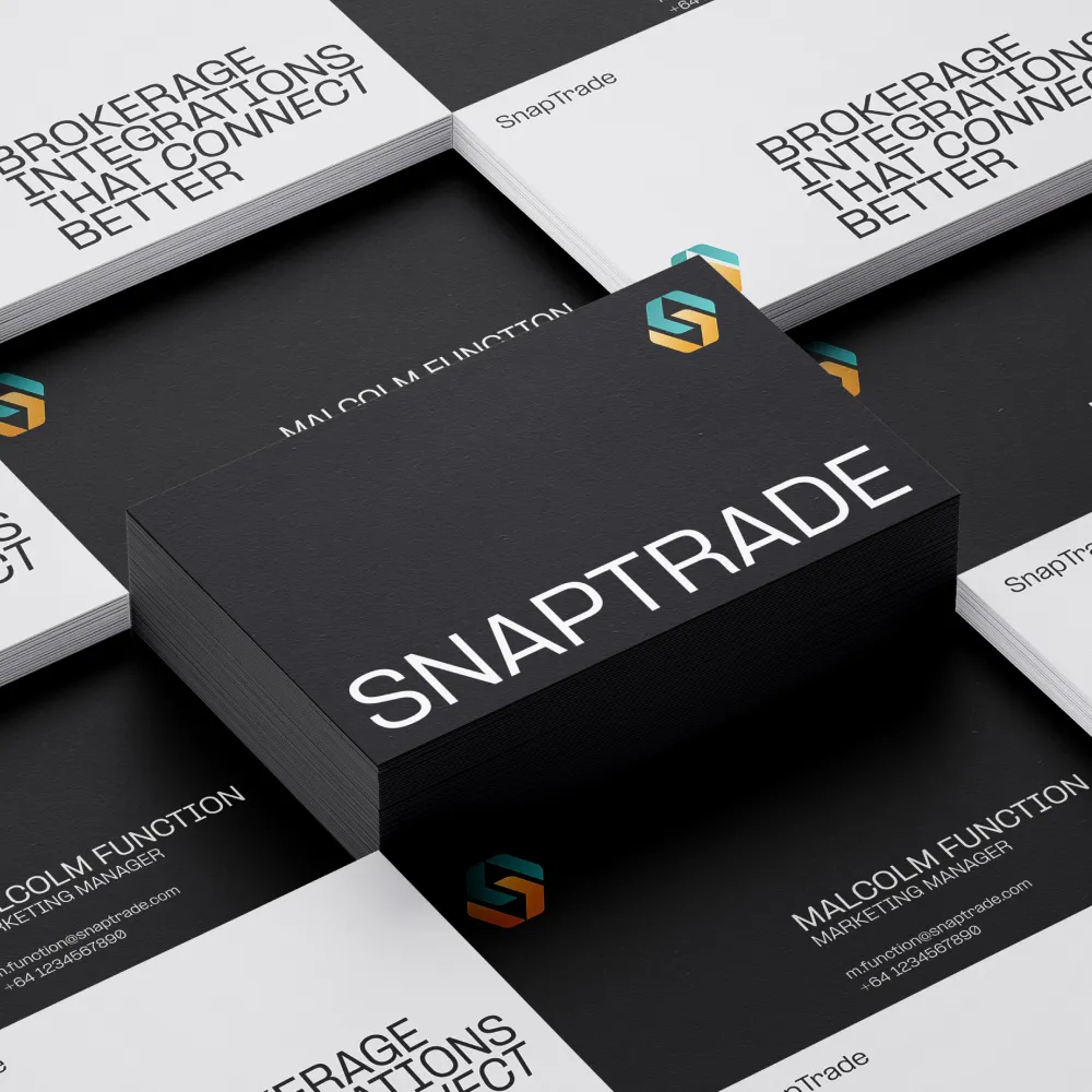 Black box with "SNAPTRADE" branding surrounded by white business cards with text "BROKERAGE INTEGRATIONS THAT CONNECT BETTER" and colorful geometric logos