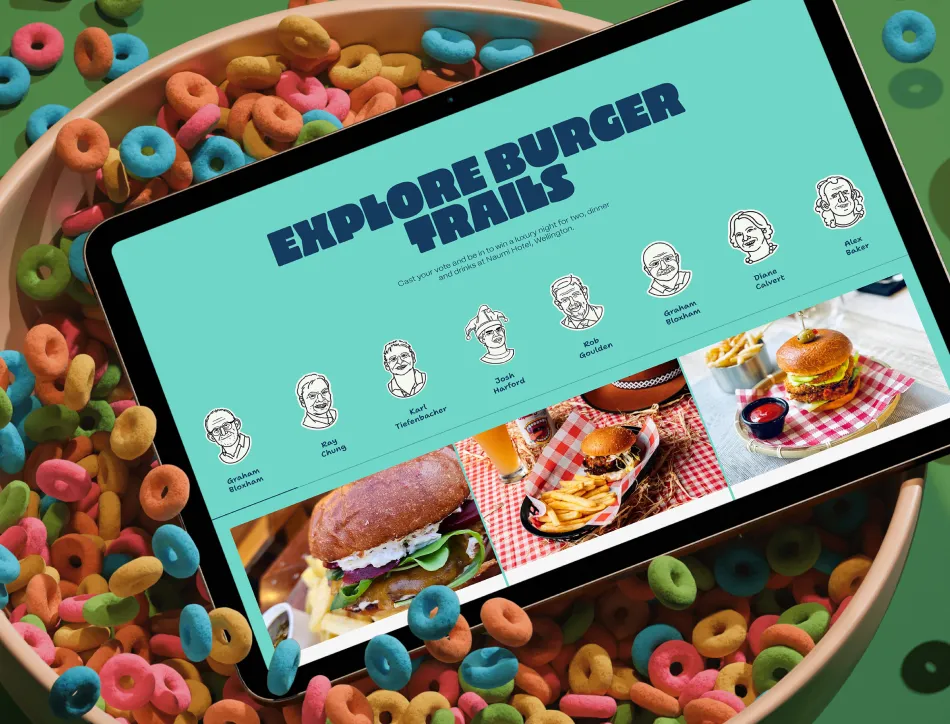 Tablet displaying "EMPLOYEE MEAN SATISFACTION" dashboard with employee avatars and food images, resting on a table with colorful cereal