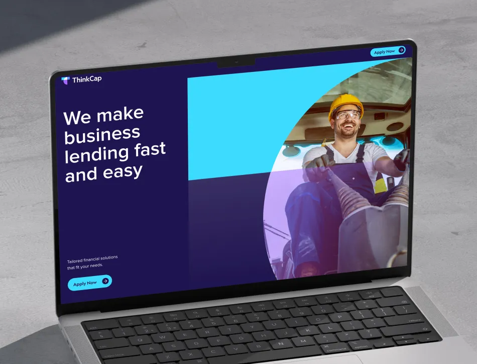 Laptop image with purple website on display with image of construction worker