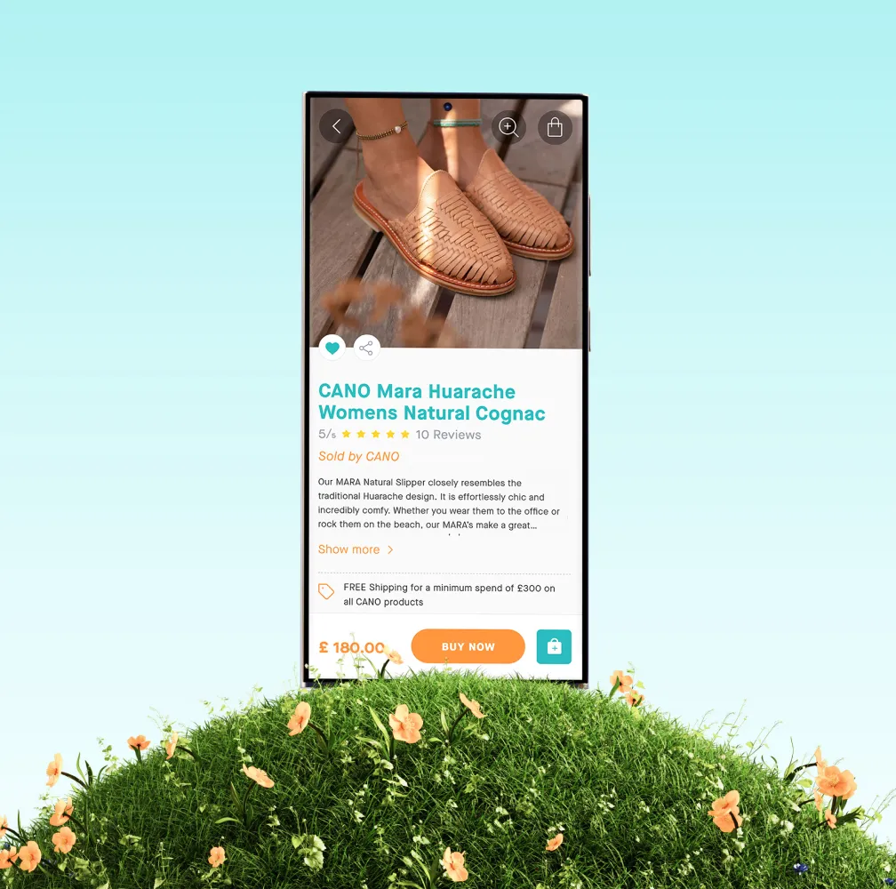 Smartphone displaying a product page for "CAMO Mars Huarache Womens Natural Cognac" sandals with product photo, star rating, description, and price of $185.00 with "BUY NOW" button, standing in green grass with small flowers