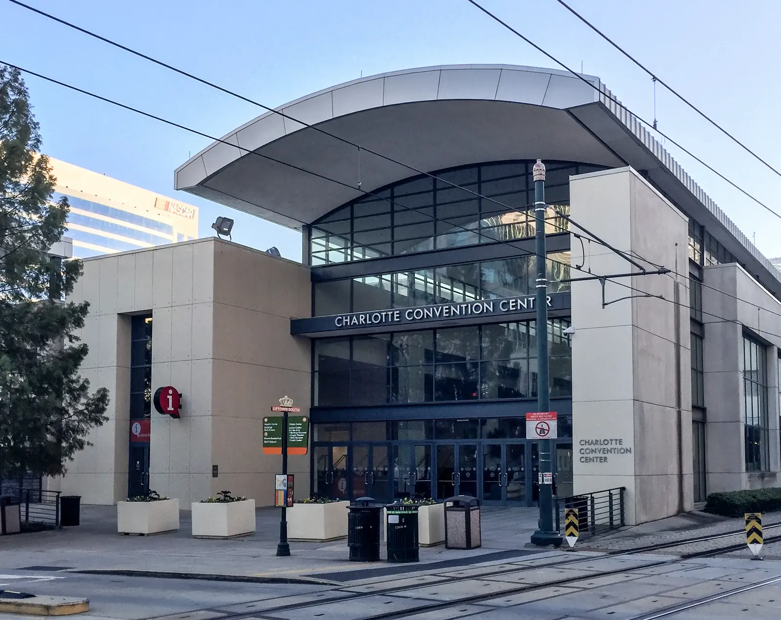 Front view of Charlotte Convention Center with glass doors and an overhead canopy.