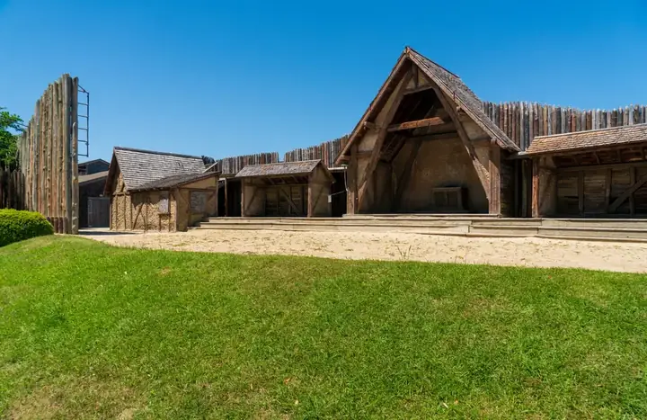 Reconstructed wooden buildings at Fort Raleigh National Historic Site, reflecting historical architecture.
