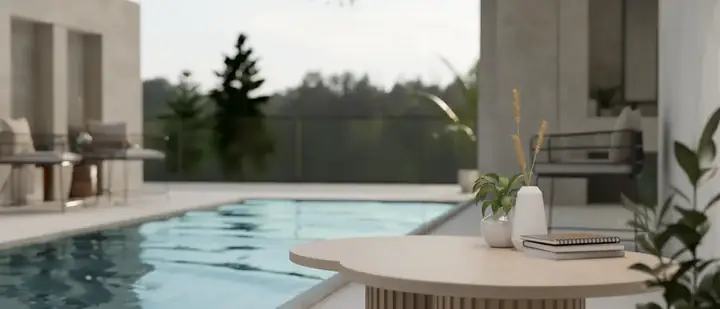 Serene poolside setting at Kingston Plantation Condos with a clear view of a tranquil lake, showcasing a modern outdoor relaxation area.