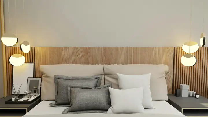 Elegantly styled Days Inn Raleigh hotel room with plush bedding, hanging spherical lamps, and a modern bedside table.