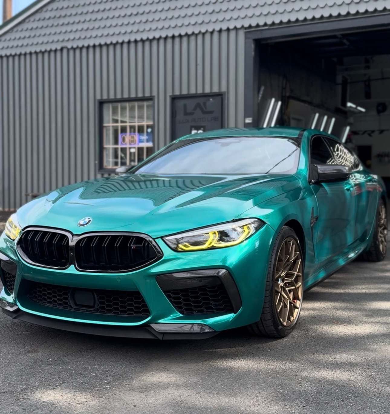 BMW M8 Gran Coupe with color-shift teal vinyl wrap by Lux Auto Lab