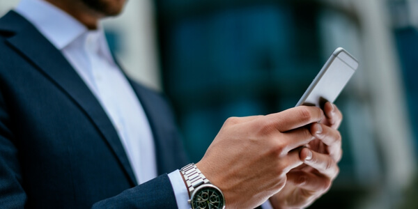 Businessman on his smartphone to check the Vodia Voice Agent