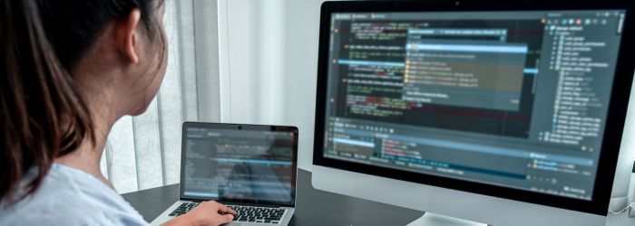 Woman working on the javascript code to build a modern IVR System