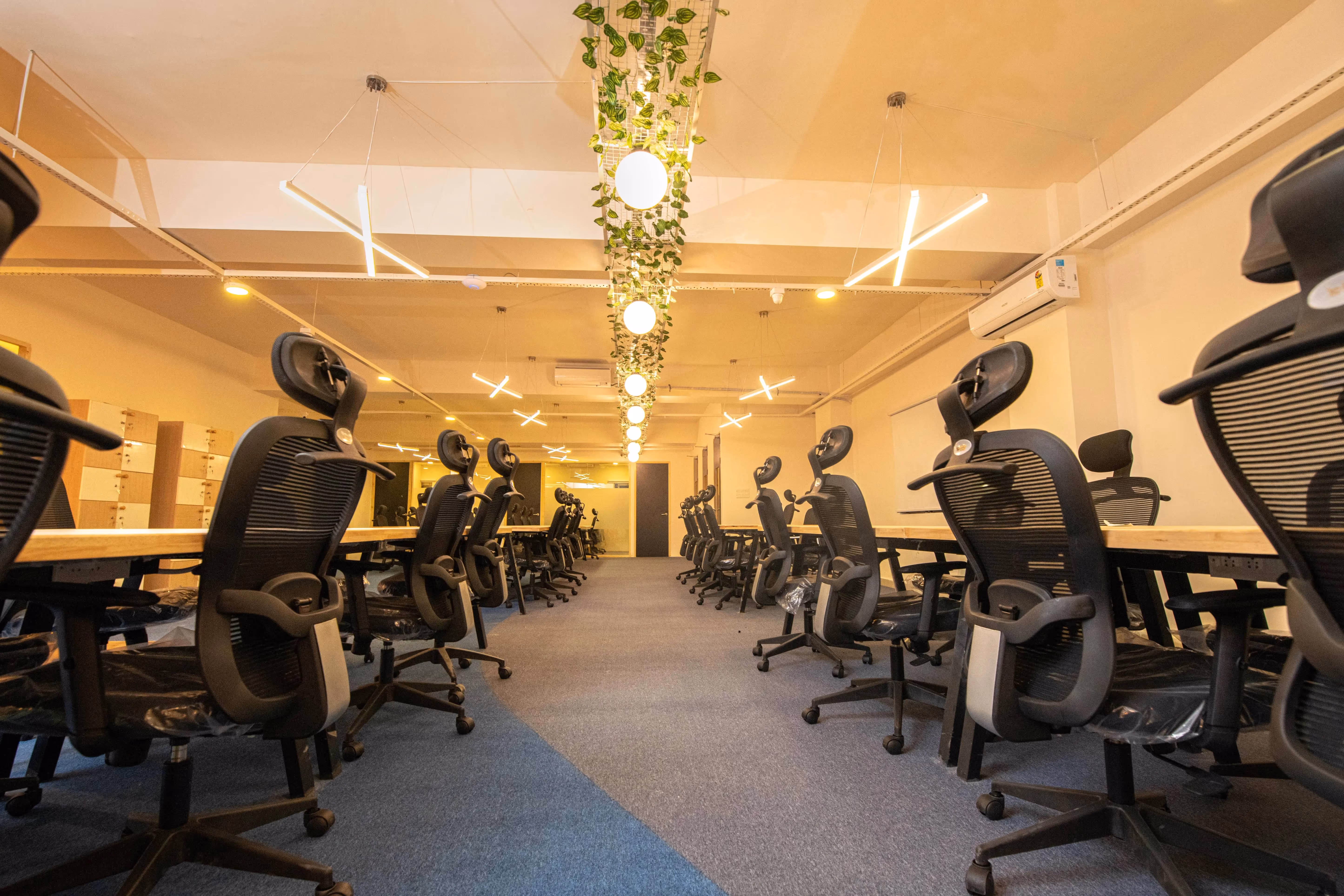 Urban Vault hall-style office furnished with chairs, computers, and tables