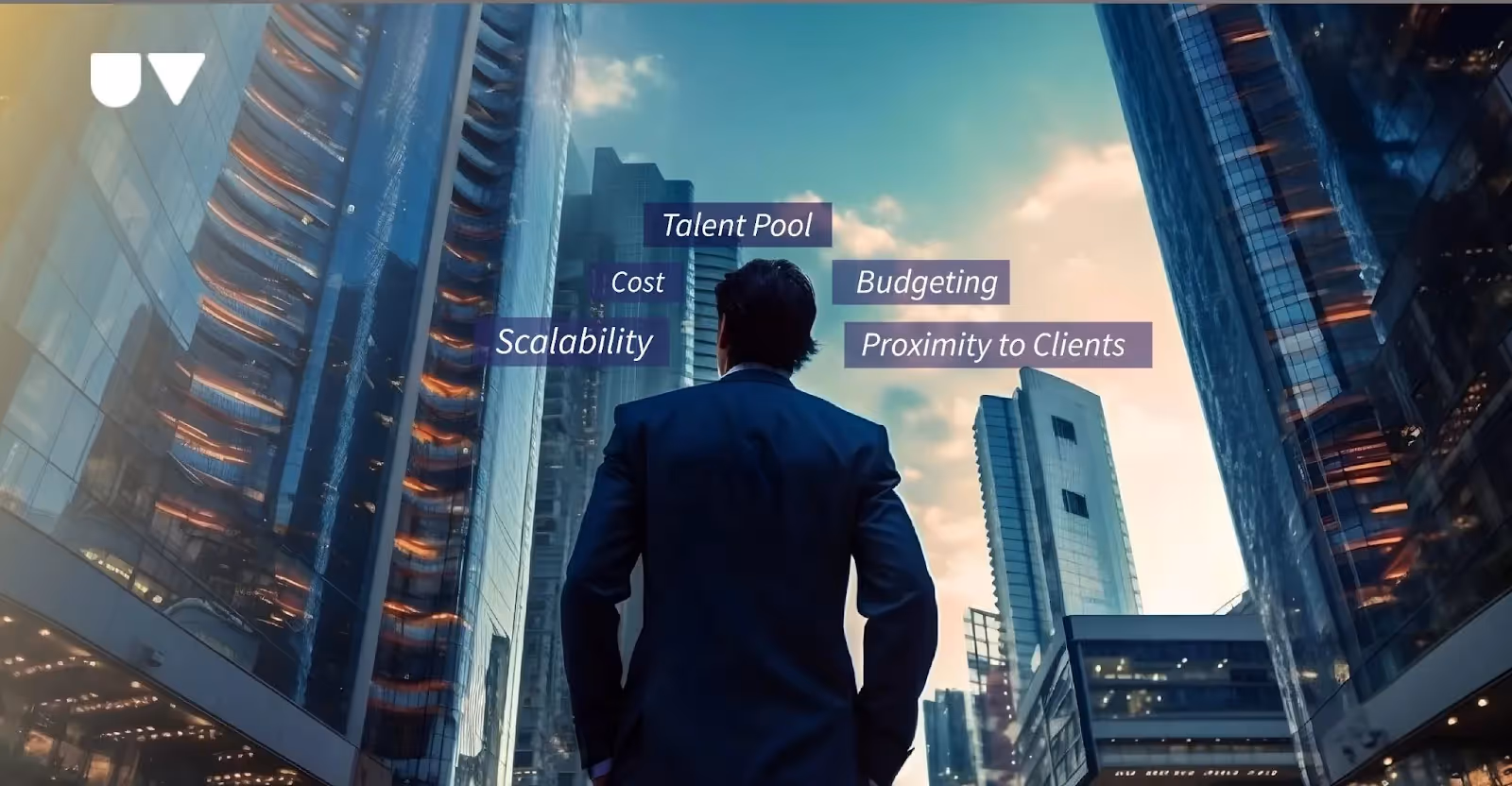 A man standing near tall office buildings.