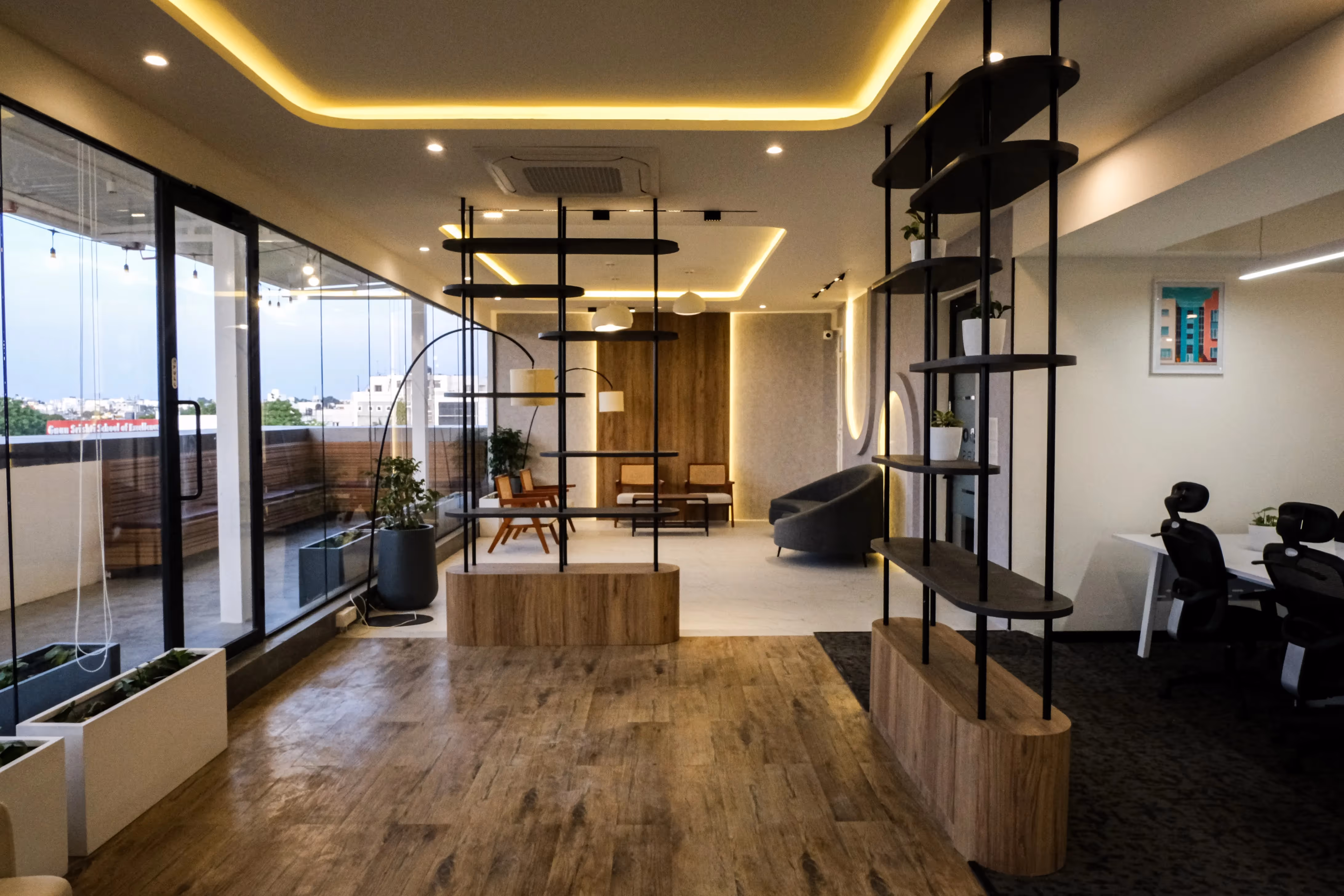 Spacious room in Baner with large window, modern furnishings, chair, table, and a lobby-style interior