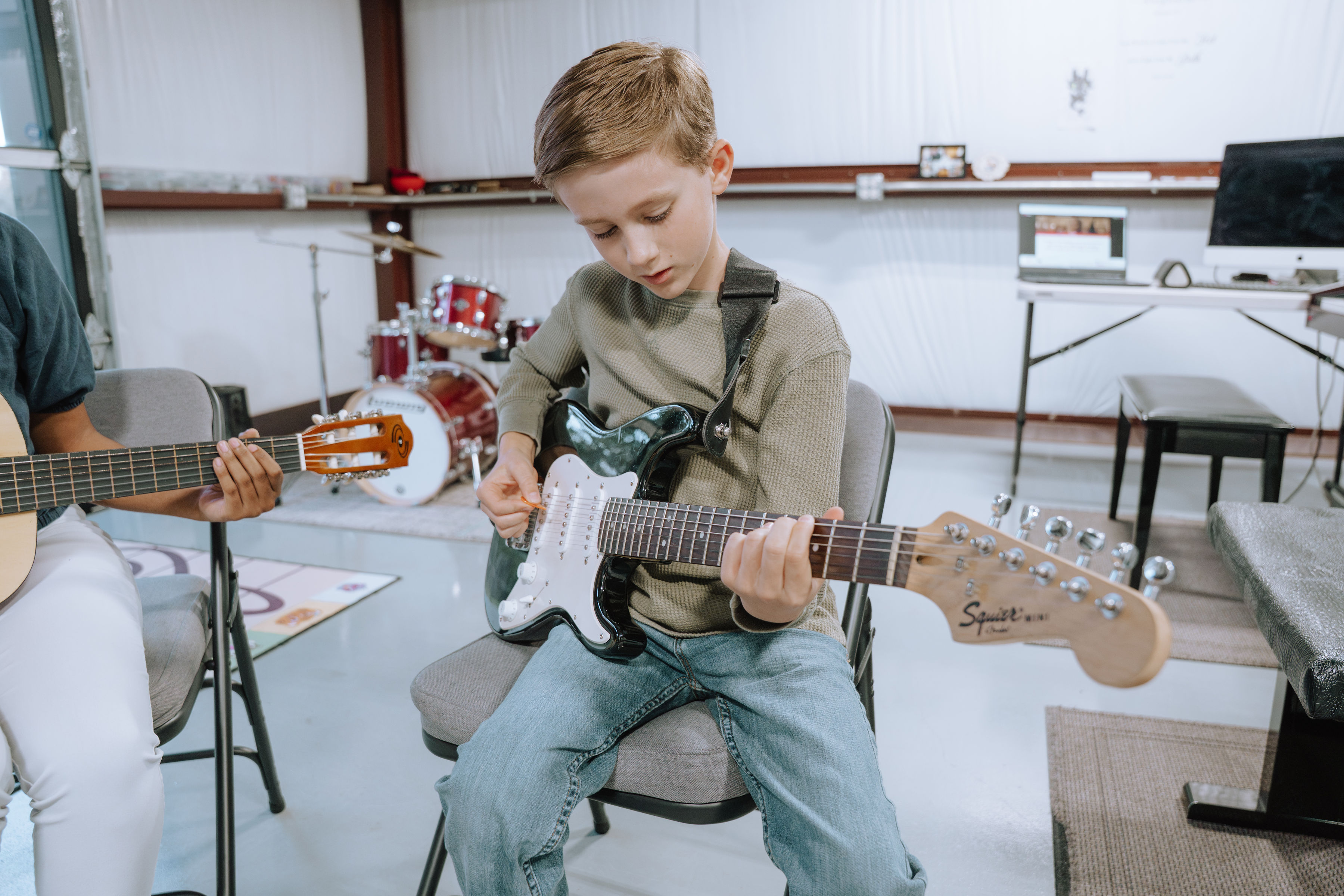 Young guitar student taking lessons at Benbrook Music Academy, February promotion, Benbrook and Fort Worth area