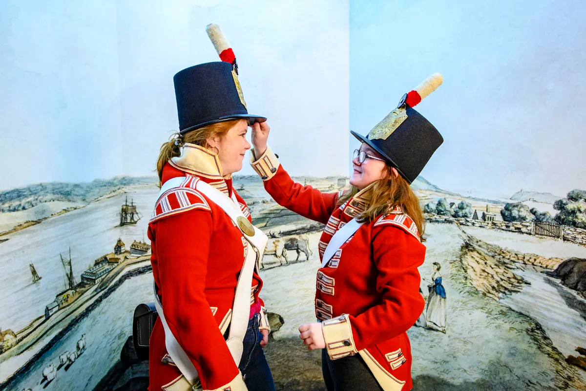 Two friends, dressed in period costume, have fun at the Halifax Citadel.