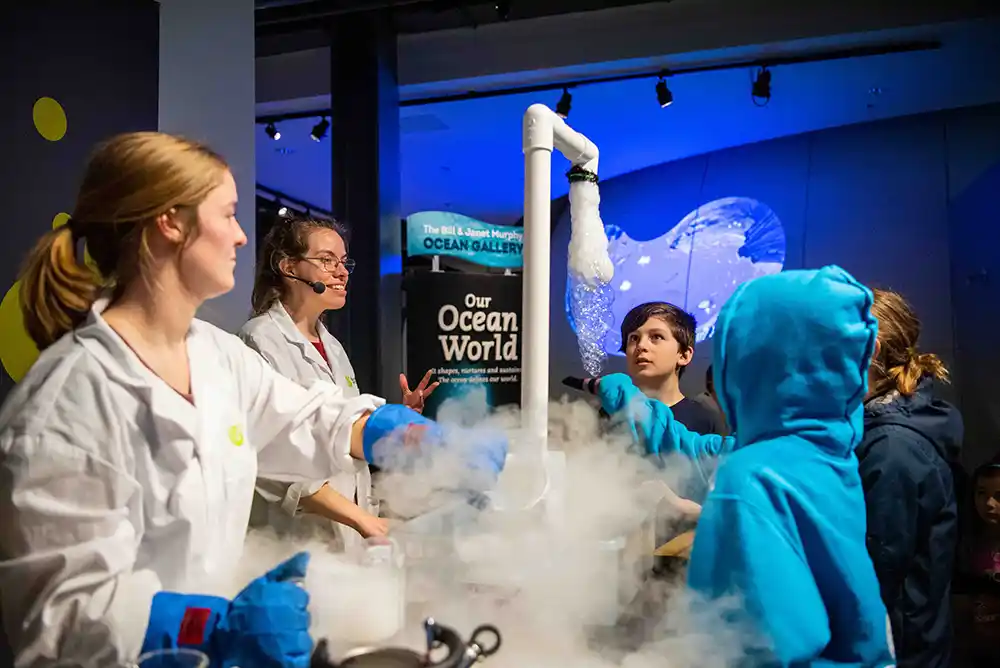 A few children gather to learn from a science instructor at the Discovery Centre in Halifax.