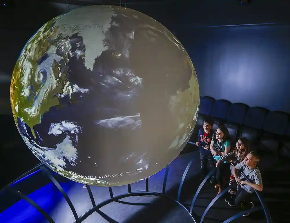 A group of children view the Museum of Natural History Science on a Sphere exhibit in Halifax, Nova Scotia.
