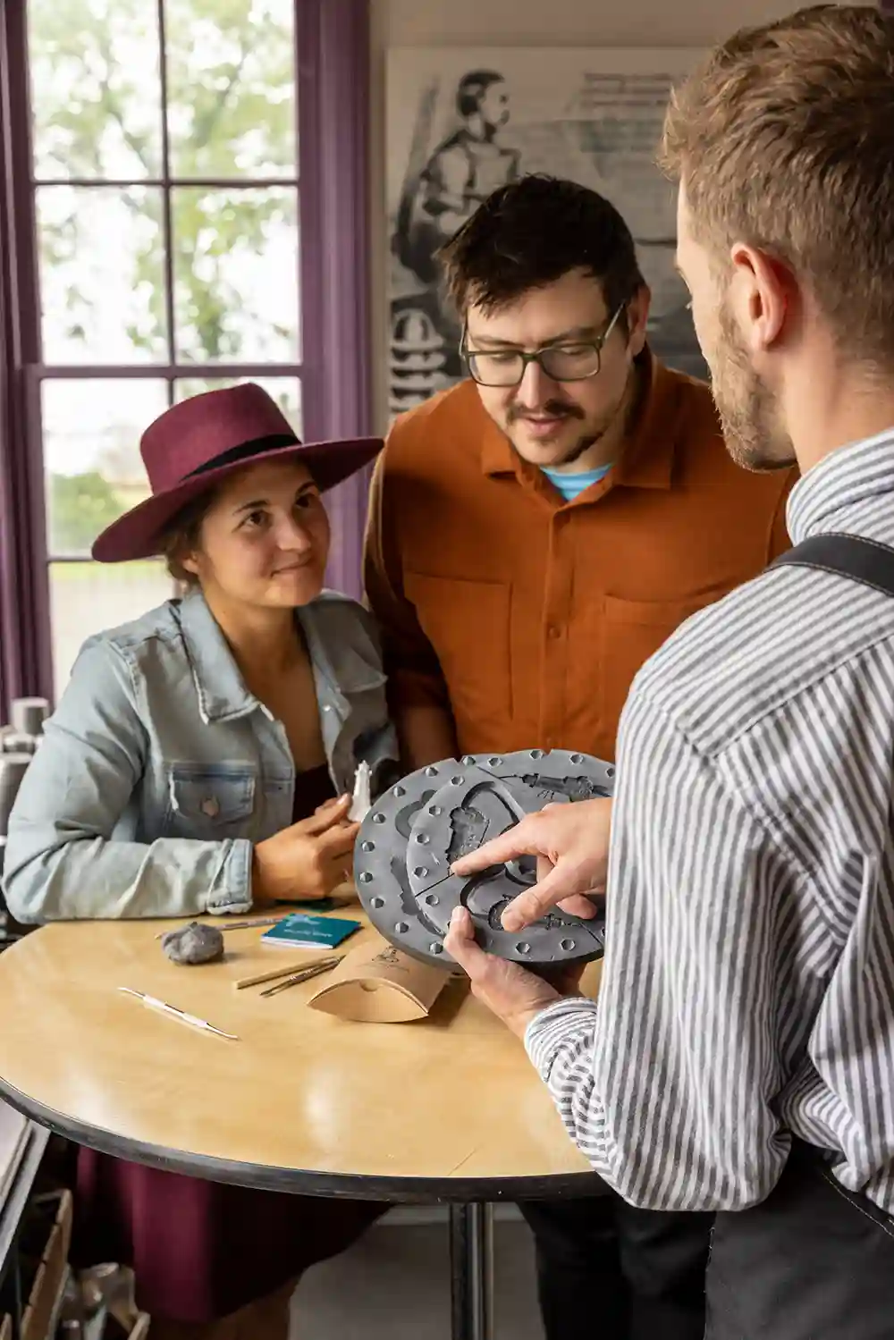 A couple enjoy a presentation from an Amos Pewter staff member.