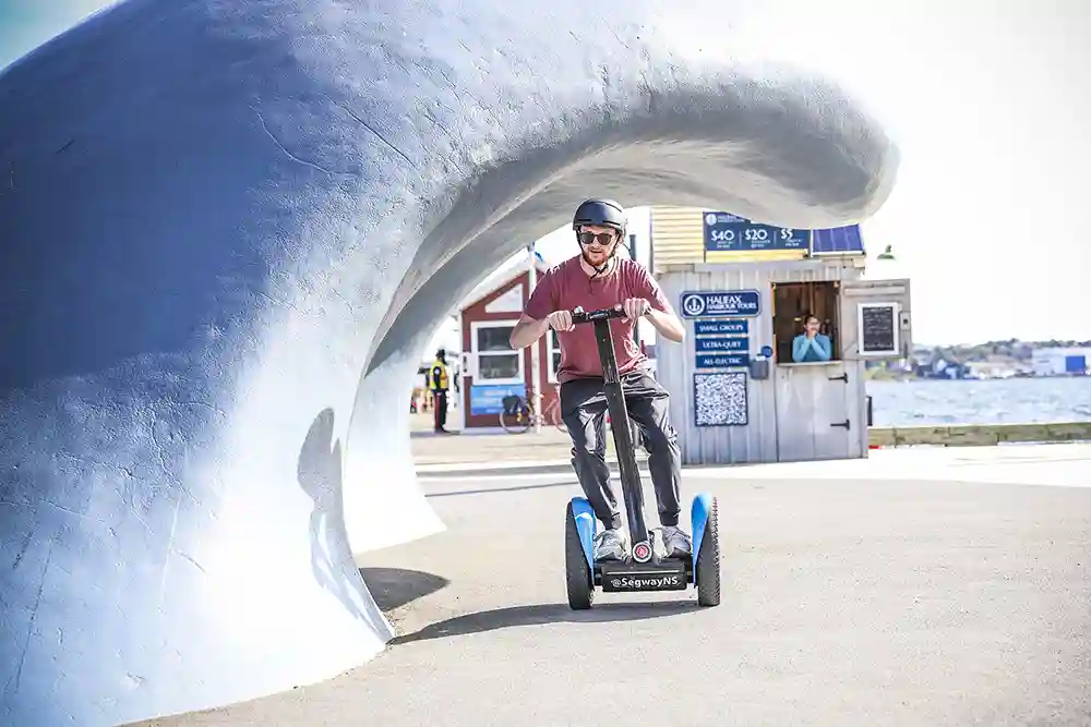 A man zooms around the "Waterfront Wave" onboard a Segway