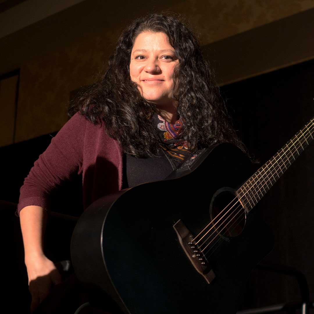 a portrait of an artist with their guitar