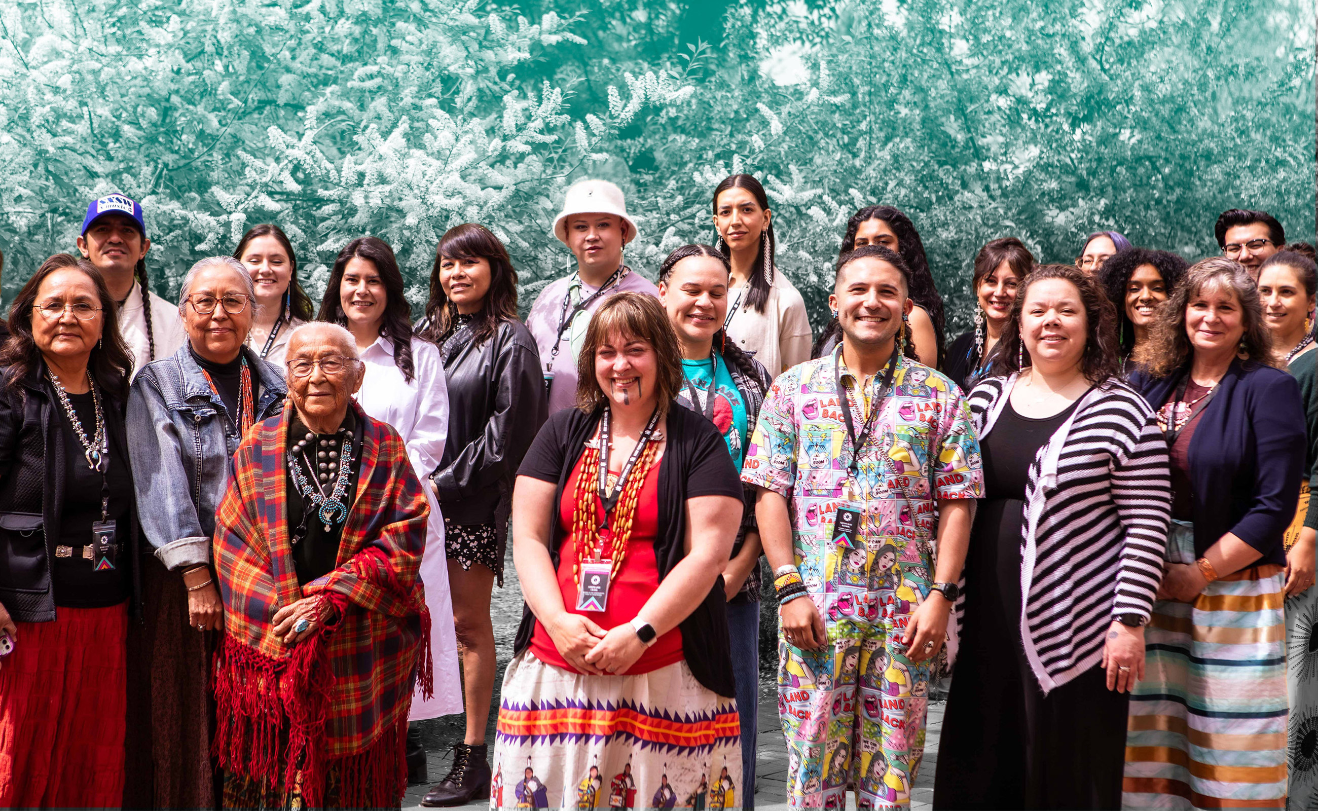 A group of 31 Native artists and culture bearers standing on a stair case smiling for the photo. Photograph from the 2016 Fellowship Convening.